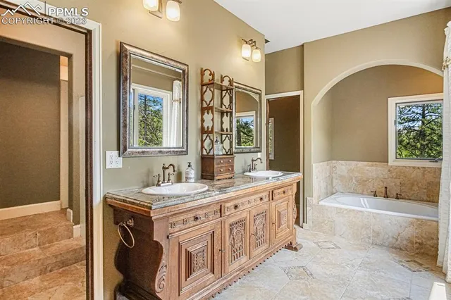 a bathroom with a sink a vanity and a bathtub