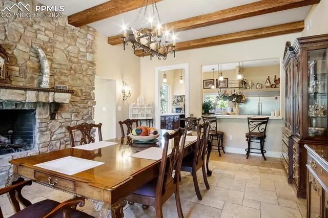 a view of a dining room with furniture and a chandelier