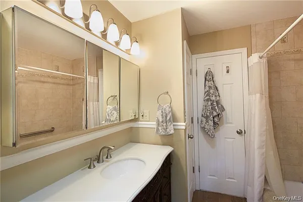 a bathroom with a shower sink and mirror