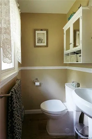 a white toilet sitting next to a bathroom sink