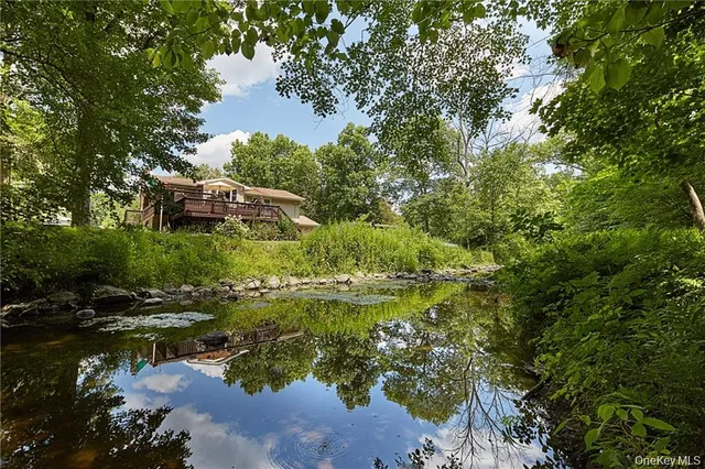 a backyard of a house with a yard and outdoor seating