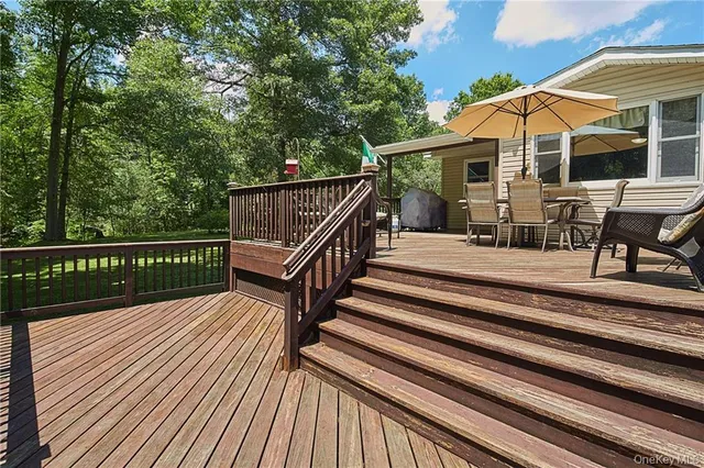 a view of a roof deck with wooden floor and fence