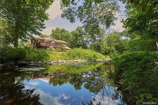 a backyard of a house with a yard and outdoor seating