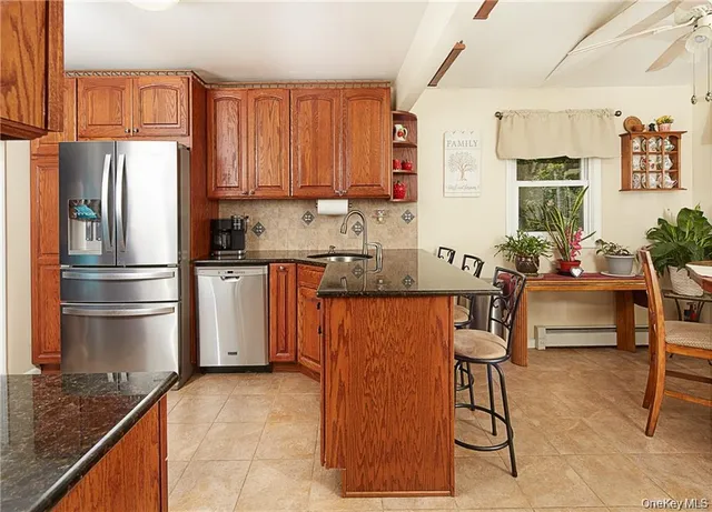 a kitchen with stainless steel appliances granite countertop a refrigerator and a stove top oven