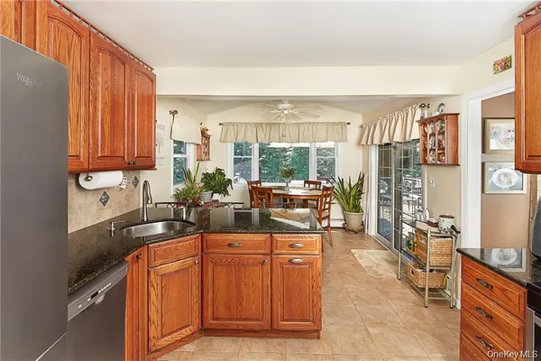 a kitchen with stainless steel appliances granite countertop a sink and cabinets