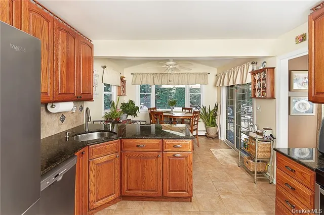 a kitchen with stainless steel appliances granite countertop a sink and cabinets