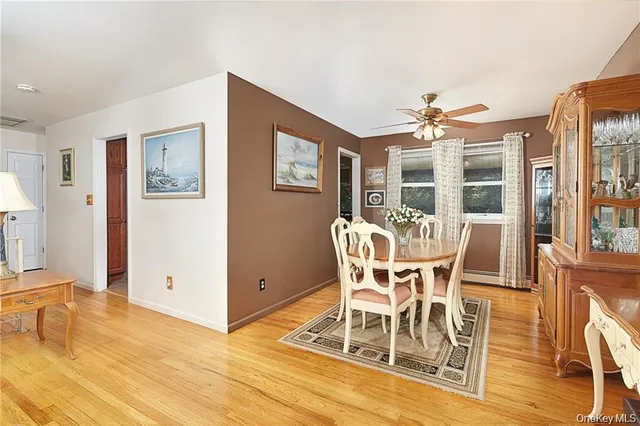 a dining room with furniture a chandelier and wooden floor