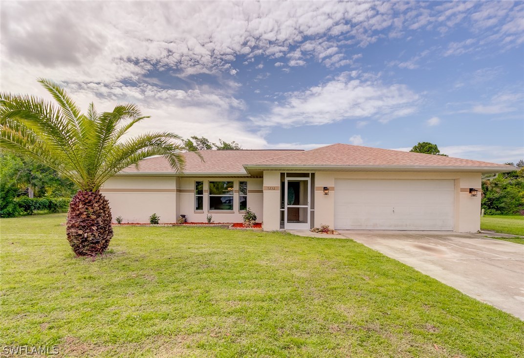 7232 Coolidge Road Fort Myers, FL 33967 - Photo 1 of 25 a view of a house with a big yard and potted plants