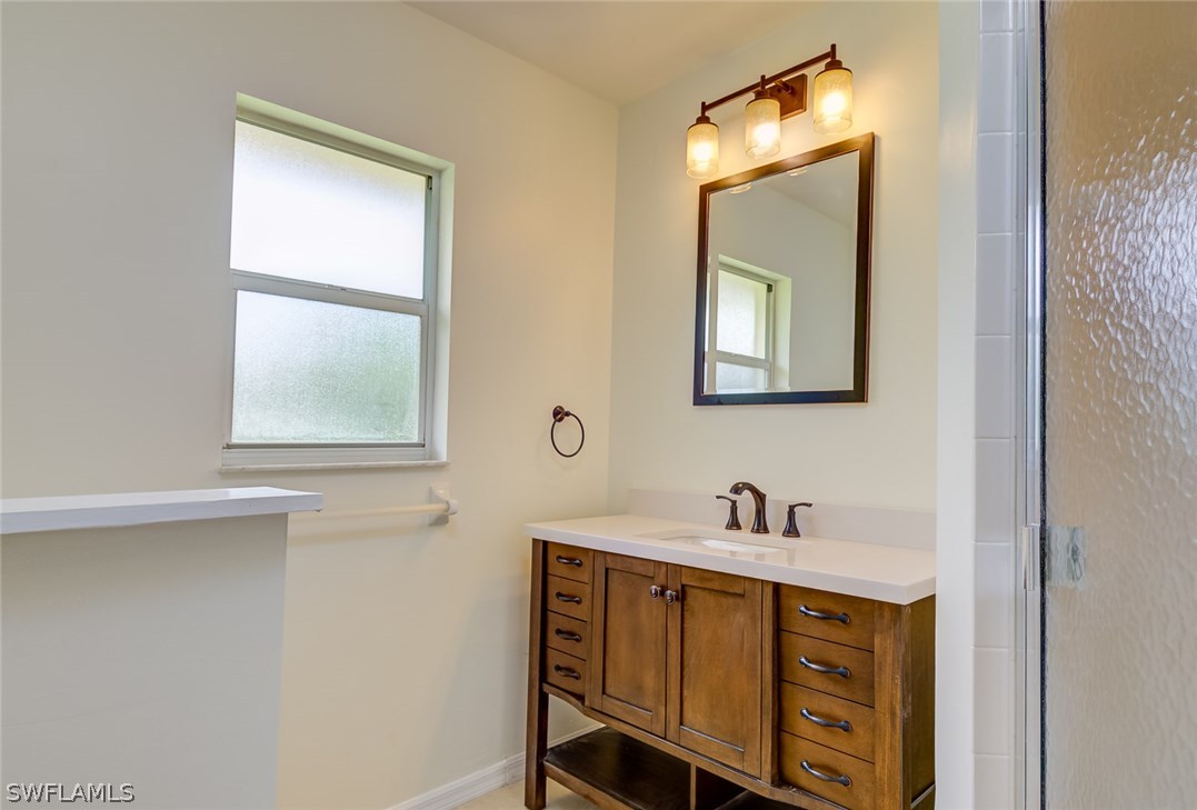 7232 Coolidge Road Fort Myers, FL 33967 - Photo 14 of 25 a bathroom with a sink mirror and a window