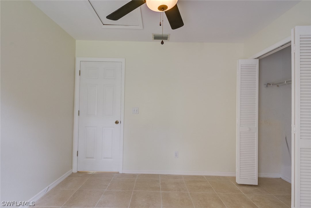 7232 Coolidge Road Fort Myers, FL 33967 - Photo 19 of 25 an empty room with a ceiling fan