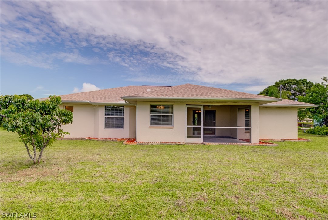 7232 Coolidge Road Fort Myers, FL 33967 - Photo 25 of 25 a view of a house with a yard and a large tree