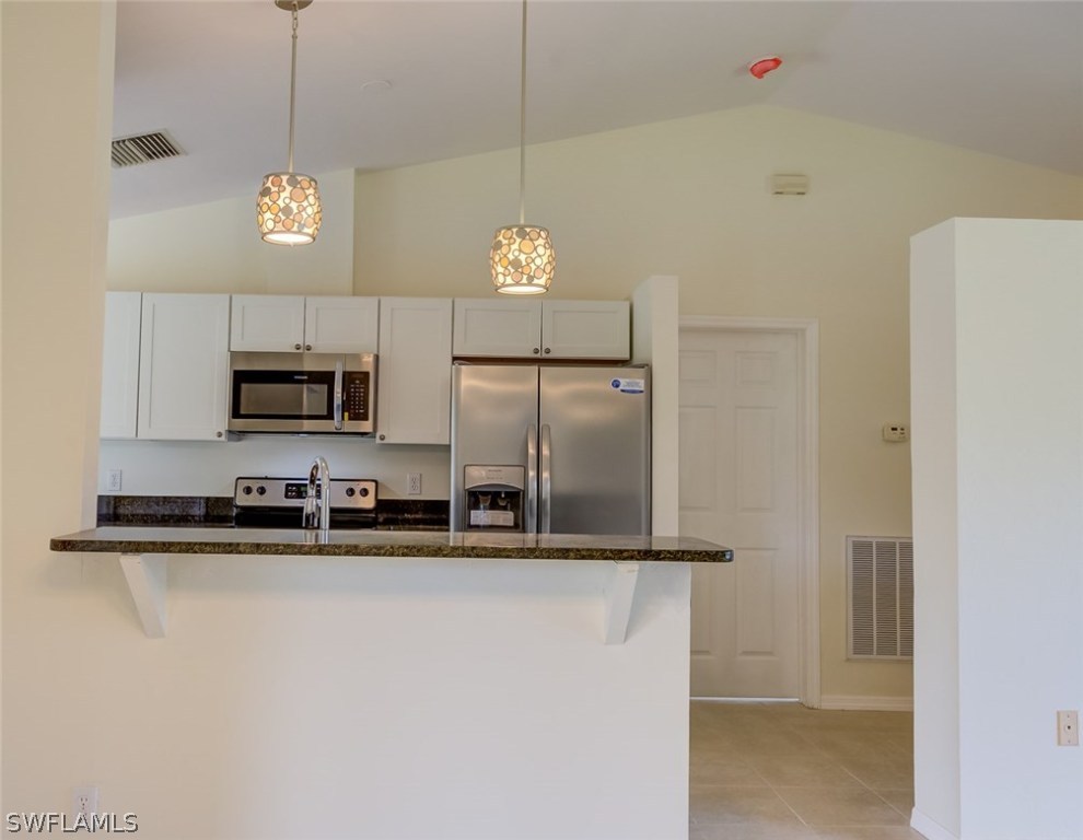 7232 Coolidge Road Fort Myers, FL 33967 - Photo 3 of 25 a kitchen with stainless steel appliances granite countertop a refrigerator a stove and a sink