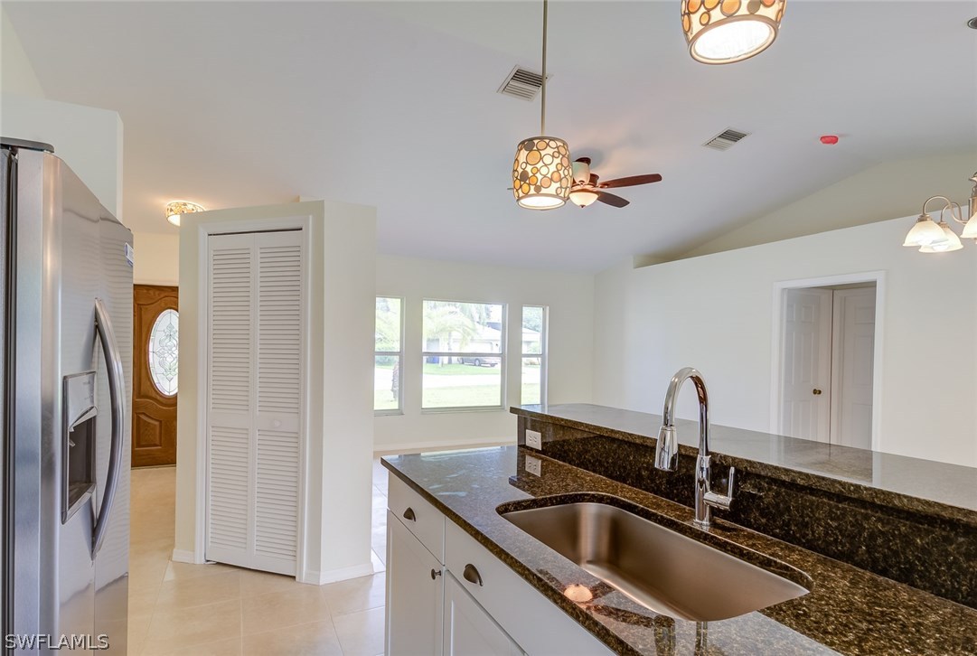 7232 Coolidge Road Fort Myers, FL 33967 - Photo 6 of 25 a kitchen with stainless steel appliances granite countertop a sink a refrigerator and a counter top space