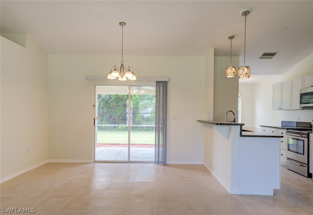7232 Coolidge Road Fort Myers, FL 33967 - Photo 8 of 25 a view of a kitchen with a chandelier