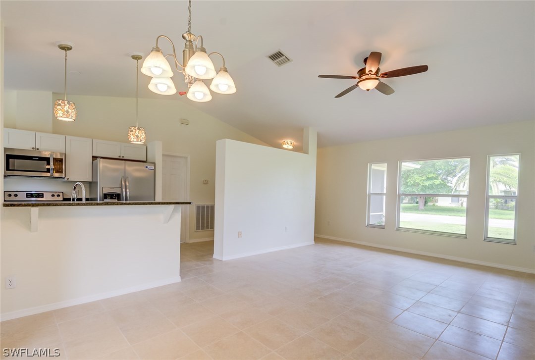 7232 Coolidge Road Fort Myers, FL 33967 - Photo 9 of 25 a view of a kitchen with microwave and a ceiling fan