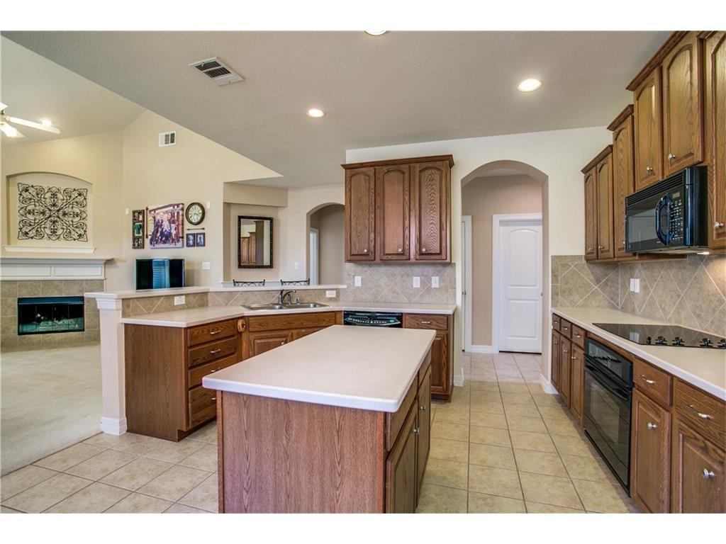 5720 Pebble Ridge Drive McKinney, TX 75070 - Photo 6 of 24 Kitchen with island and a lot of cabinets.