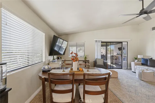 a view of a dining room with furniture and window