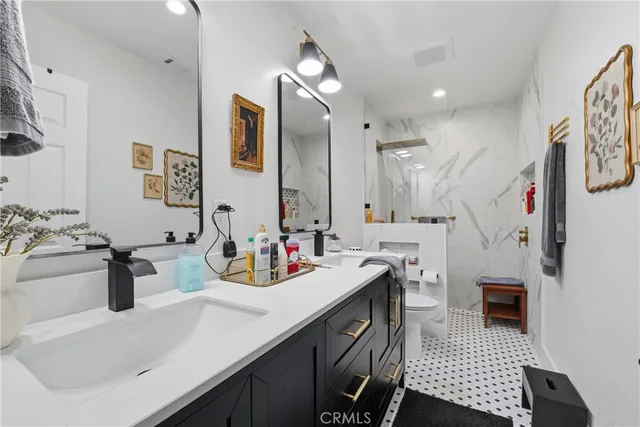 a bathroom with a sink double vanity and a mirror