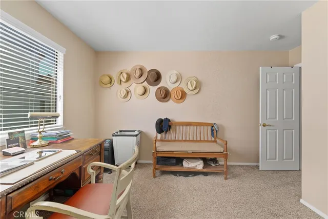 a bedroom with a bed and large windows
