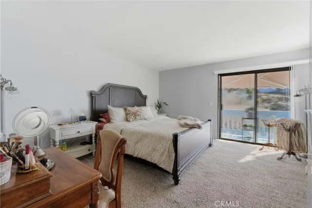 a bedroom with a bed and a potted plant