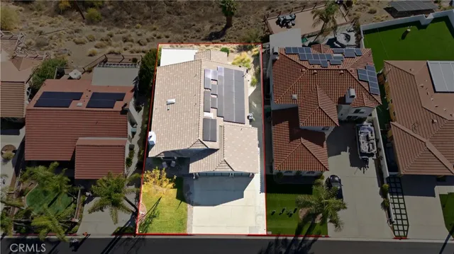 an aerial view of multiple houses with a yard