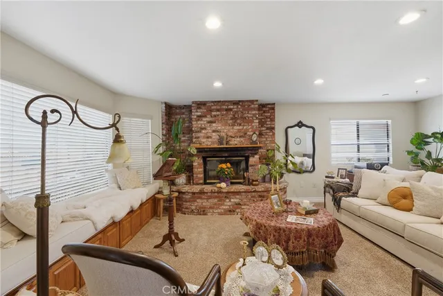 a living room with furniture a fireplace and a table