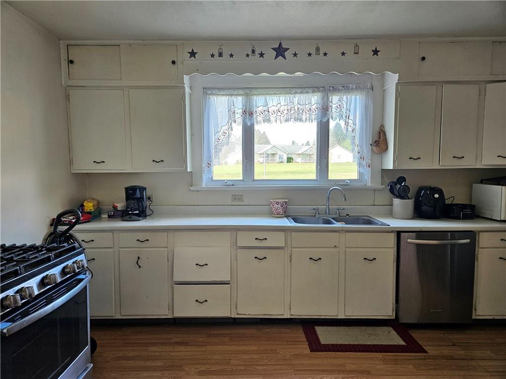 121 North Road Butler, PA 16001 - Photo 9 of 39 a kitchen with granite countertop white cabinets window and stainless steel appliances