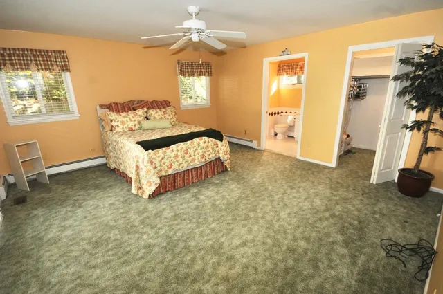 a spacious bedroom with a bed and a window