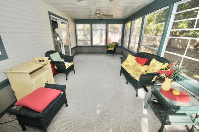 a living room with furniture and a floor to ceiling window