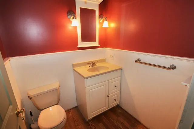 a bathroom with a toilet sink and mirror