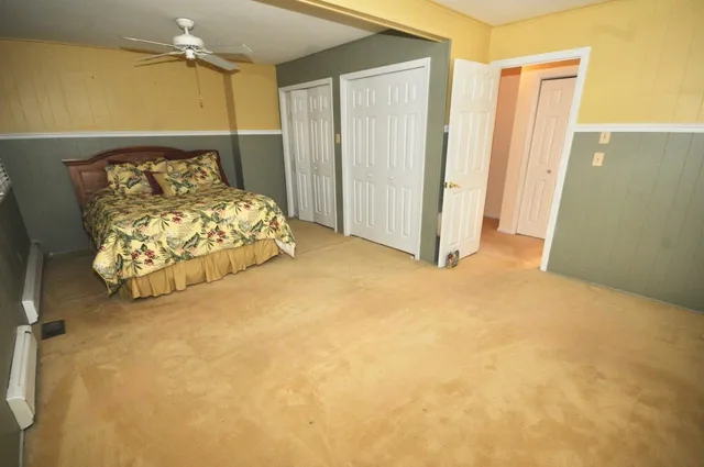 a bed sitting in a room next to a window