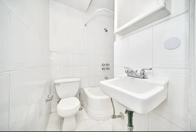 a white toilet sitting next to a bathroom sink