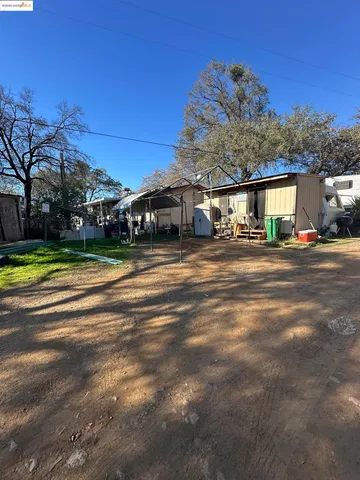 a big house with a big yard and large trees