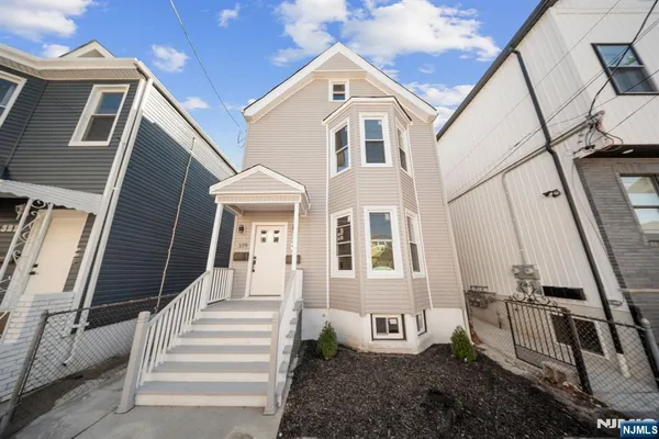a view of a room with wooden floor and white walls