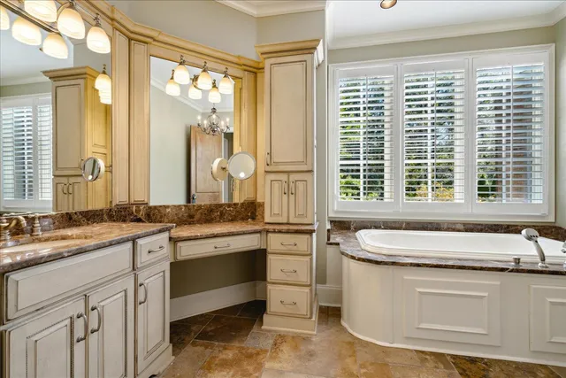 a bathroom with a granite countertop sink and a large mirror