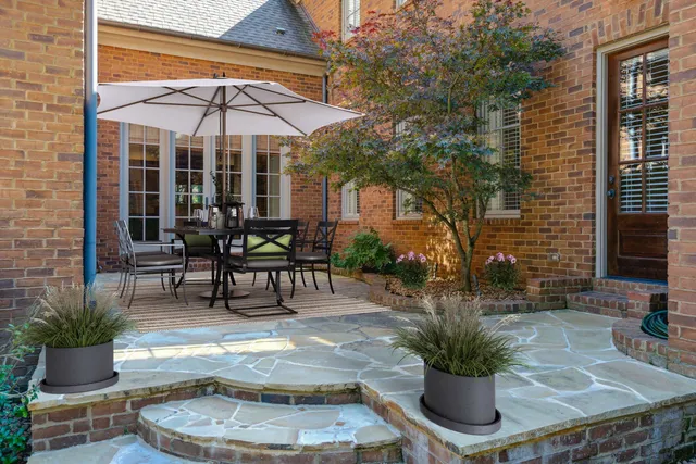 a patio with a table and chairs