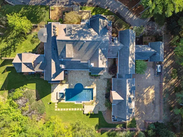 an aerial view of a house with a swimming pool