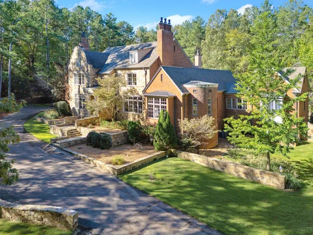 a view of a house with backyard and sitting area