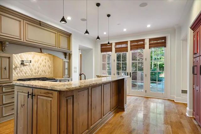 a kitchen with stainless steel appliances granite countertop a sink and wooden cabinets
