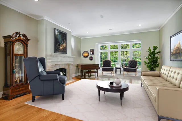 a living room with furniture a rug and a large window