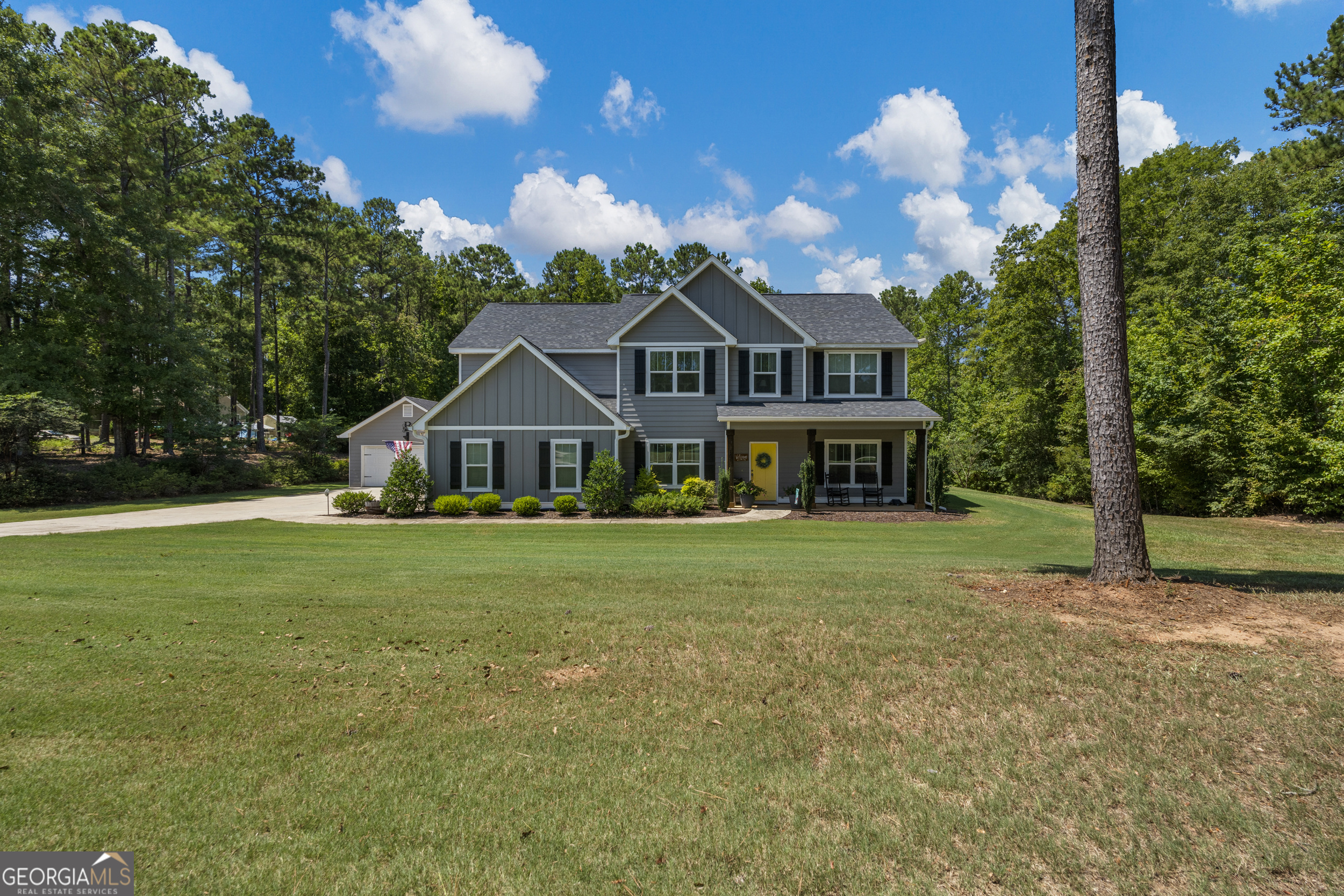 a front view of house with yard and green space