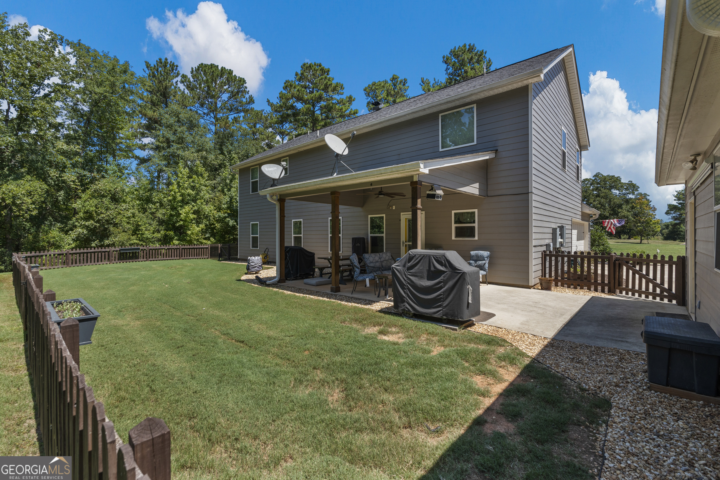 209 Marsh Road West Point, GA 31833 - Photo 2 of 50 a view of a patio with table and chairs potted plants and a palm tree