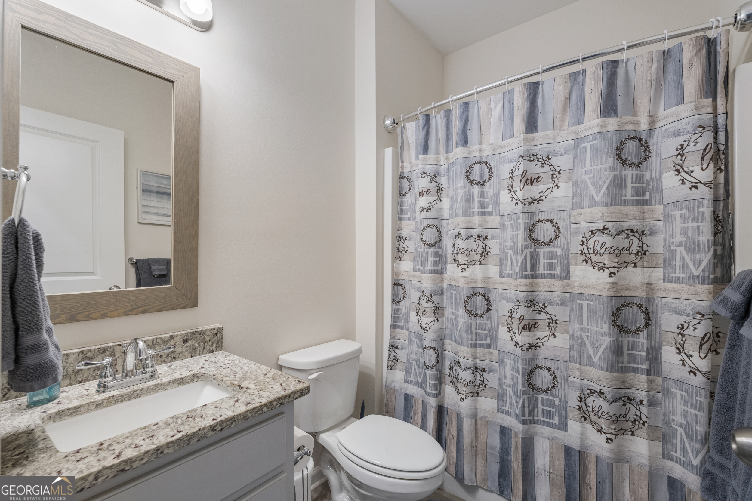 209 Marsh Road West Point, GA 31833 - Photo 29 of 50 a bathroom with a granite countertop toilet sink mirror and shower