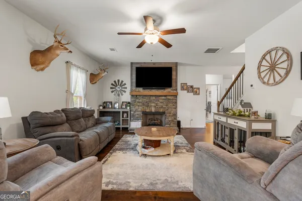 a living room with furniture a fireplace and a flat screen tv