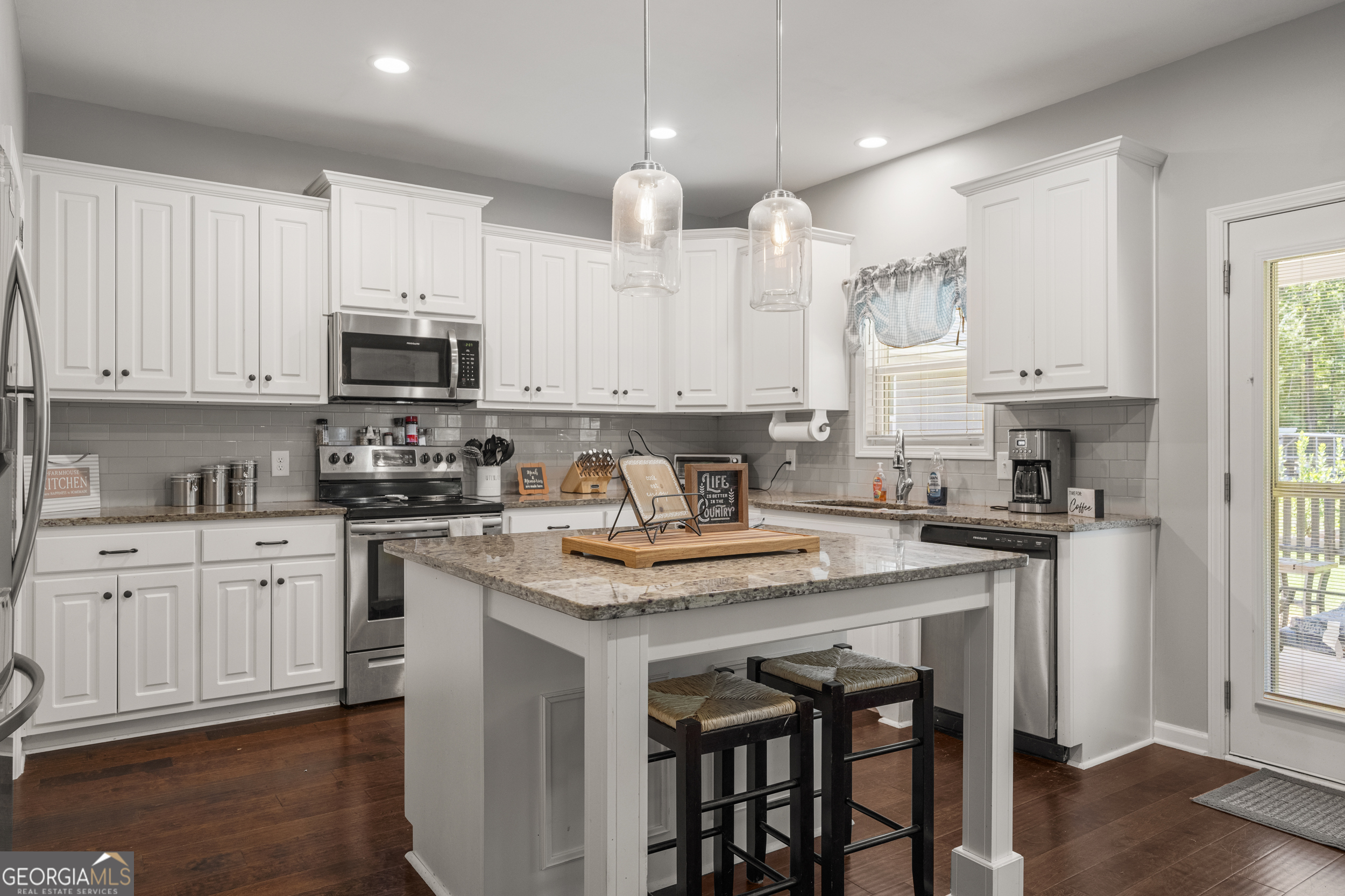 209 Marsh Road West Point, GA 31833 - Photo 9 of 50 a kitchen with stainless steel appliances granite countertop a stove a sink a microwave a refrigerator and white cabinets
