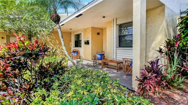 view of the patio with table and chairs and potted plants
