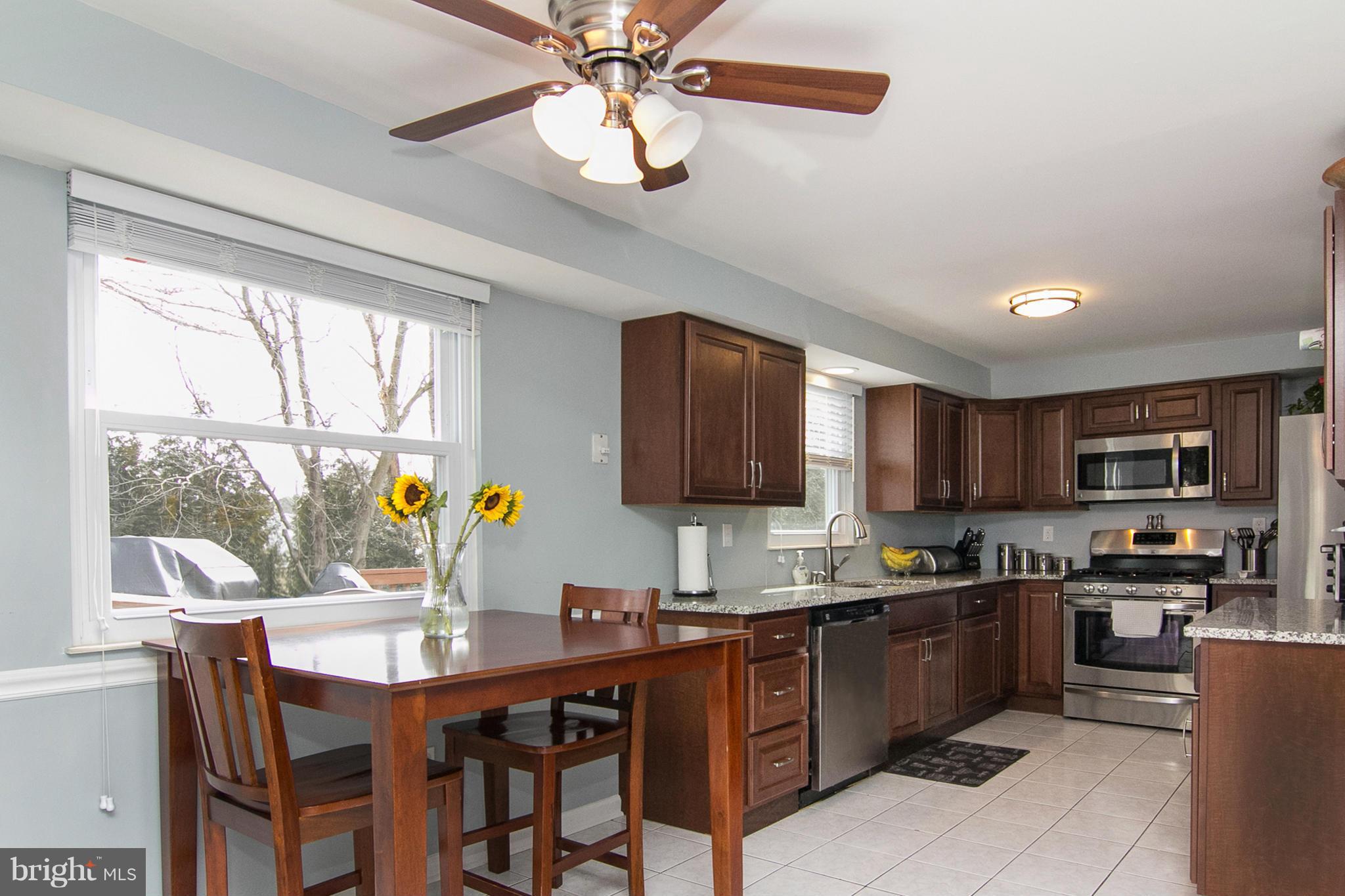 343 Timber Grove Road Owings Mills, MD 21117 - Photo 2 of 29 a kitchen with a window a sink and cabinets