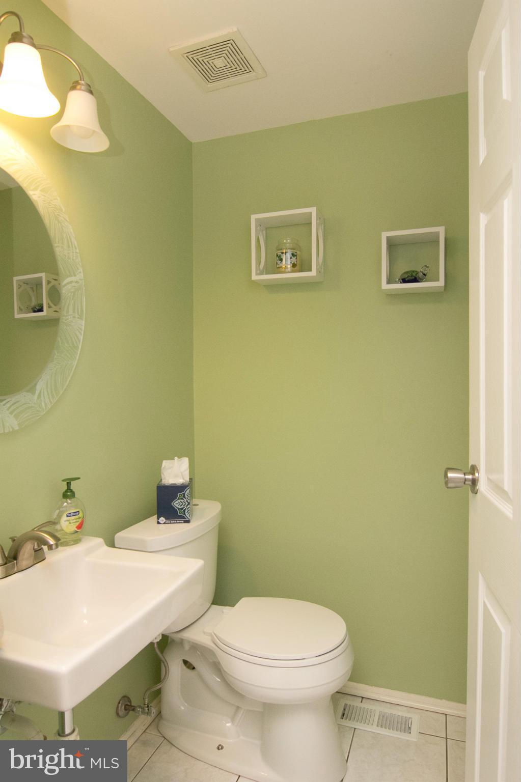343 Timber Grove Road Owings Mills, MD 21117 - Photo 11 of 29 a bathroom with a toilet a sink and mirror