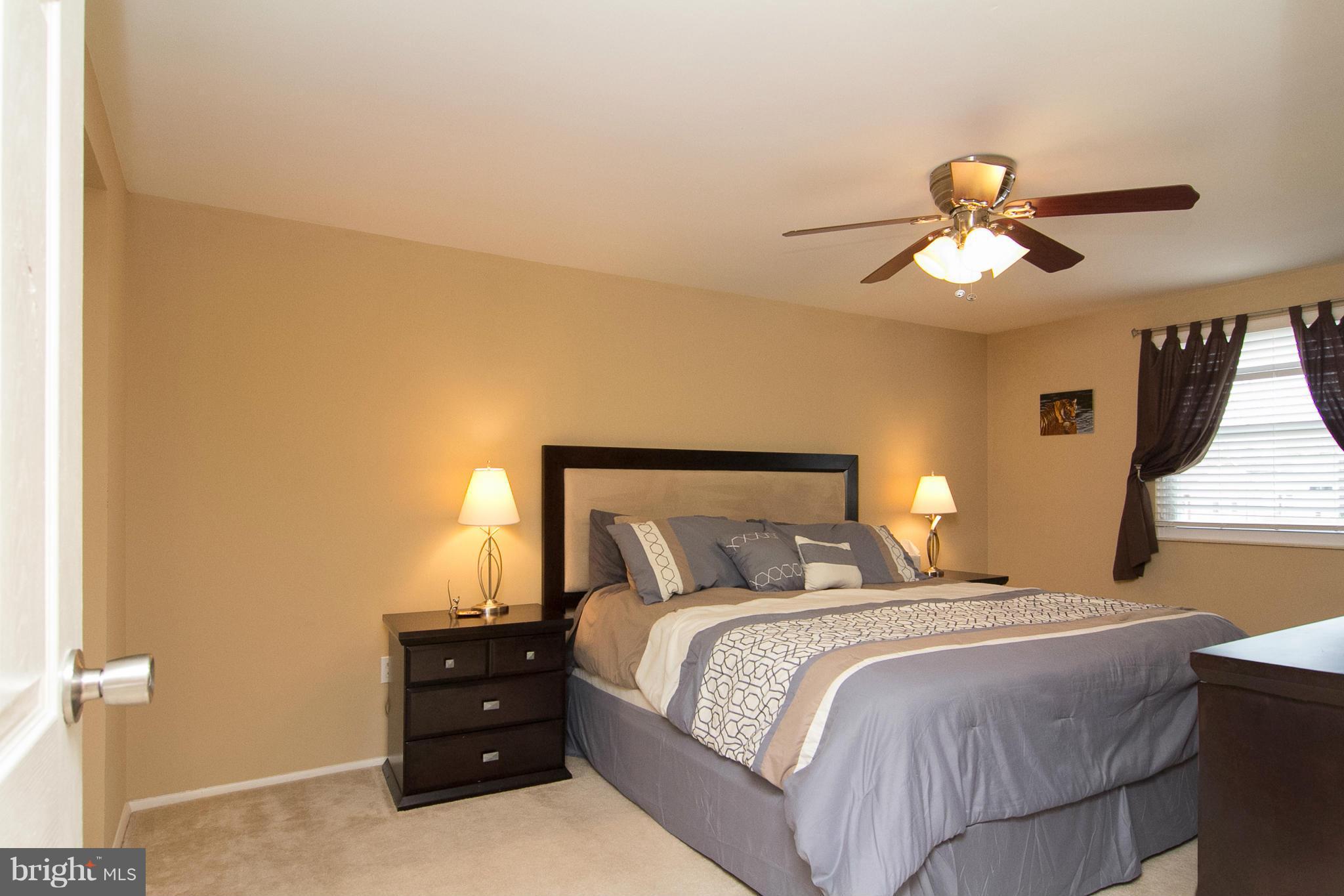 343 Timber Grove Road Owings Mills, MD 21117 - Photo 13 of 29 a bedroom with a bed and a chandelier