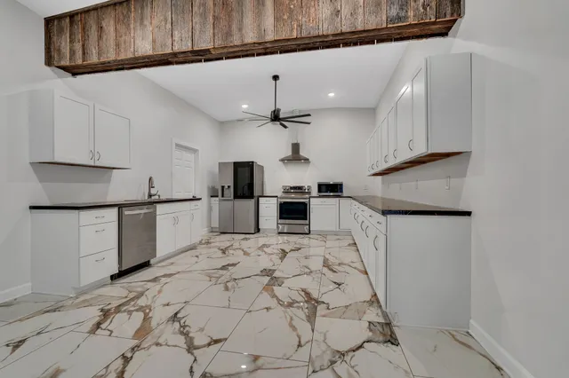 a kitchen with a refrigerator a sink and cabinets